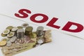 Pile of Canadian money with sold sign Royalty Free Stock Photo