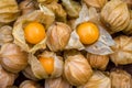 Pile of cape gooseberry on sale in the market. Physalis Fruits on a black basket background.