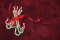 Pile Caramel sugar canes tied with a red ribbon on a red background. Christmas background. Concept of Christmas and New Year. Cara