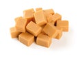 Pile of caramel vanilla fudge isolated on white background. Fresh tasty candies made of milk and sugar. Square pieces of delicious