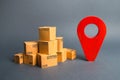 A pile of cardboard boxes and a red position pin. Locating packages and goods. Algorithm for constructing a minimum route