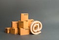 Pile of cardboard boxes and symbol email. shopping. E-commerce. sales of goods and services through online trading platforms.