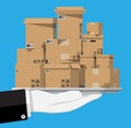 Pile cardboard boxes in tray in hand Royalty Free Stock Photo