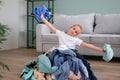 Pile of carelessly scattered clothes on floor.The child puts things in order in the room Royalty Free Stock Photo