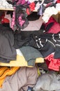 Pile of carelessly scattered clothes in wardrobe