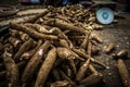 Pile of cassavas near a scale on sale in traditional market in Bogor Indonesia Royalty Free Stock Photo