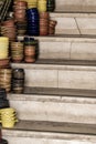 Pile of ceramic bowls of various sizes and colors on stairs Royalty Free Stock Photo