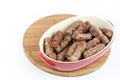 Pile of cevapcici kebabs in the bowl isolated over white background
