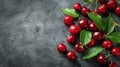 Pile of cherry with leaf and water drops on black stone table. Ripe ripe cherries. Royalty Free Stock Photo