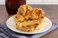 Pile of Chicken and Waffles on a Rustic Wooden Counter Royalty Free Stock Photo