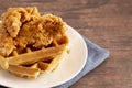 Pile of Chicken and Waffles on a Rustic Wooden Counter