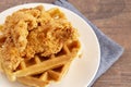 Pile of Chicken and Waffles on a Rustic Wooden Counter Royalty Free Stock Photo