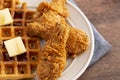 Pile of Chicken and Waffles on a Rustic Wooden Counter Royalty Free Stock Photo