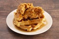 Pile of Chicken and Waffles on a Rustic Wooden Counter Royalty Free Stock Photo