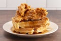 Pile of Chicken and Waffles on a Rustic Wooden Counter Royalty Free Stock Photo