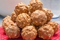 A pile of chocolate nut clusters resting on a red silicone baking pad Royalty Free Stock Photo
