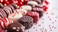 A pile of chocolates with red and white stripes on a table Royalty Free Stock Photo