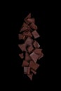 Pile chopped, milled chocolate isolated on black background