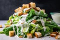 pile of chopped romaine, croutons, and creamy caesar dressing