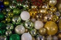 Many Christmas balls in white, gold,silver and green tones and shades.