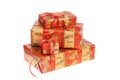 Pile of Christmas gifts wrapped with red and golden paper with ornaments and glitter ribbon. Isolated on white background Royalty Free Stock Photo