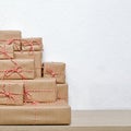 A pile of Christmas gifts wrapped in rustic paper