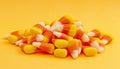 A Pile of Classic Candy Corn on Yellow Orange Background