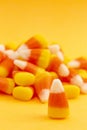 A Pile of Classic Candy Corn on Yellow Orange Background