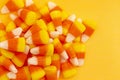 A Pile of Classic Candy Corn on Yellow Orange Background