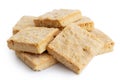 Pile of classic homemade square shortbread biscuits isolated on