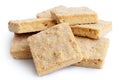 Pile of classic homemade square shortbread biscuits isolated on