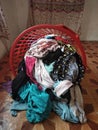 pile of clean clothes that have been laundered in a red basket