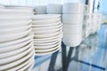 Pile of clean dishes plates and cups on a table prepared by the catering service Royalty Free Stock Photo