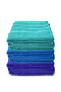 Pile of clean terry bath colored towels isolated on a white background, close-up, copy space, concept of cleanliness, bath Royalty Free Stock Photo