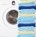 Pile of clean towels with washing machine Royalty Free Stock Photo