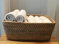 Pile of cloth, hand towel, table napkin, handkerchief on the basket in spa, bath room, toliet with blur white wooden wall backgrou Royalty Free Stock Photo