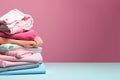 Pile of clothes ready for laundry. Stack of colorful clothes. Laundry day, fabric recycling concept. Fashion industry pollution,