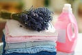 Pile of clothes, softener and bunch of lavender Royalty Free Stock Photo