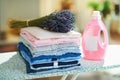 Clothes, softener and bunch of lavender on ironing board Royalty Free Stock Photo