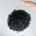Pile of coconut shell activated carbon powder isolated on white background