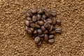 Pile of cofee seeds on instant granulated cofe background