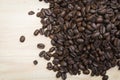 Pile of coffee beans on bright wooden background Royalty Free Stock Photo