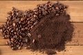 Pile of Coffee Beans and Grounds in Middle of Wood Royalty Free Stock Photo