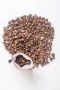 Pile of coffee beans and jute drawstring bag on the white background Royalty Free Stock Photo