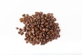 Pile of coffee beans on a white surface. Background and texture. Top view Royalty Free Stock Photo