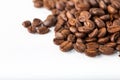 Pile of coffee beans on a white surface. Background and texture. Top view Royalty Free Stock Photo