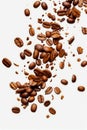 Pile of coffee beans on white surface with few scattered around. Generative AI Royalty Free Stock Photo