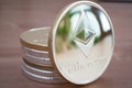 Pile of Coin of Silver Ethereum on wooden background