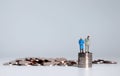 A pile of coins and miniature people. Royalty Free Stock Photo