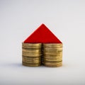 pile of coins and a model of a house on a light background. Business metaphor. Royalty Free Stock Photo